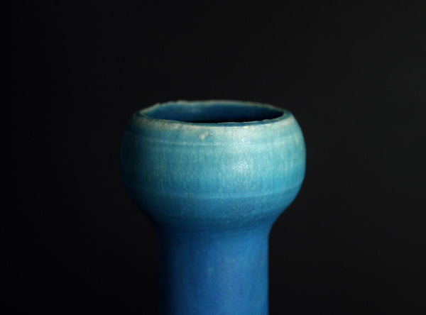 Blue ceramic vase on a black background