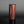 Load image into Gallery viewer, Cylindrical vase with black and red striped design on a gray background
