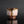 Load image into Gallery viewer, A handmade ceramic sake cup with a textured, organic glaze in pink, brown, and white, featuring a dripping amber glaze detail, set against a dark gray reflective background.
