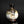 Load image into Gallery viewer, A small ceramic bottle or vase with a bulbous rounded body, dark brown glazed neck, and a mottled white and brown glaze, photographed against a dark studio background.
