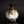 Load image into Gallery viewer, A small ceramic bottle or vase with a bulbous rounded body, dark brown glazed neck, and a mottled white and brown glaze, photographed against a dark studio background.
