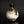 Load image into Gallery viewer, A small ceramic bottle or vase with a bulbous rounded body, dark brown glazed neck, and a mottled white and brown glaze, photographed against a dark studio background.
