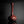 Load image into Gallery viewer, A glossy dark reddish-brown ceramic vase with a bulbous base and a long, slender neck, standing on a reflective black surface against a dark gray background.
