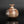 Load image into Gallery viewer, A small handmade ceramic vase with a bulbous body and short neck, featuring a marbled glaze in earthy brown, beige, and white tones, set against a dark reflective background.
