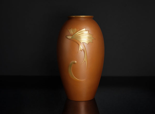 Brown vase with gold leaf design on a black background