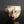 Load image into Gallery viewer, An abstract ceramic cup with a textured, organic glaze in cream, brown, black, and muted copper tones, set against a dark reflective background.
