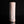 Load image into Gallery viewer, A tall, cylindrical ceramic vase with a textured, crackled glaze in pale pink and white, standing upright on a reflective black surface against a solid black background.
