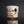 Load image into Gallery viewer, Ceramic cup with a dark spot on a reflective surface against a black background
