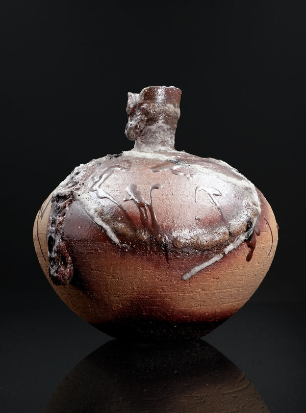 Ceramic vase with textured surface on a black background