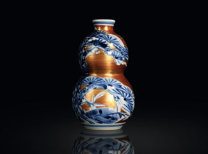 Decorative vase with blue and white floral patterns on a black background