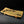 Load image into Gallery viewer, A rectangular ceramic serving tray with a light beige painted surface, decorated with black leaf motifs and small red berry accents, shown on a dark studio background.

