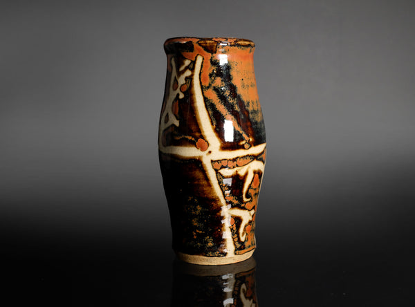 Ceramic vase with decorative patterns on a gray background