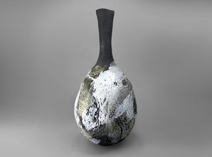 Decorative vase with textured surface on a gray background