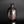 Load image into Gallery viewer, A dark brown ceramic bottle vase with a glossy, metallic finish, standing on a reflective black surface against a dark gray background.
