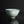 Load image into Gallery viewer, A pale celadon-green ceramic bowl with a hand-painted white moon and cloud motif, set against a dark reflective background.
