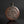 將圖片載入到圖庫檢視器中， An antique round copper vase with a floral relief design on the front, set against a dark gray background.
