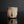 Load image into Gallery viewer, A handmade ceramic guinomi with a textured, geometric design in earthy brown, beige, and white glazes, set against a dark reflective background.
 
