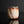 Load image into Gallery viewer, A handmade ceramic guinomi with a textured, geometric design in earthy brown, beige, and white glazes, set against a dark reflective background.
