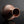 將圖片載入到圖庫檢視器中， A small copper-colored vase with a ribbed texture and a wide flared opening, photographed on a dark reflective surface against a dark gray background.

