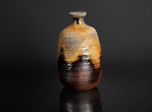 Rustic ceramic sake with a gradient finish on a black background