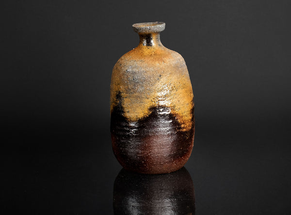 Rustic ceramic sake with a gradient finish on a black background