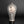 Load image into Gallery viewer, A ceramic vase with a textured gray and white glaze, featuring a circular beige inlay with a black floral illustration, set against a dark gray background.
