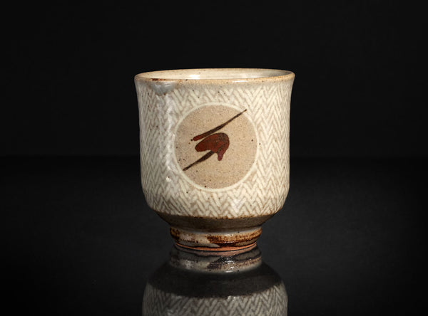 Ceramic cup with decorative patterns on a black background