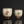 將圖片載入到圖庫檢視器中， Two ceramic cups with decorative designs on a reflective surface.
