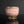 Load image into Gallery viewer, A rounded copper-red tea cup from Tatsuzo Shimaoka’s Mashiko practice, enlivened by pale cord patterns across a softly coloured pink ground. Its lower, broader proportions give it a generous open profile, offering a distinct counterpart to the taller cup with which it was originally paired.

The body curves inward beneath the wide mouth, then rounds towards a short, clearly defined circular foot. A lightly flaring rim frames the pale glazed interior. The changing contours give the cup a comfortable visual b
