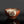 將圖片載入到圖庫檢視器中， A handmade ceramic bowl with a glossy terracotta brown finish, featuring a hand-painted decorative motif on the front with red, green, and blue lines on a white background, set against a dark gray gradient background.
