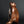 Load image into Gallery viewer, A sculptural monkey-shaped incense burner by Tsuda Eiju, distinguished by its upright seated pose and smoothly modelled brown surface. The animal raises its face, creating a lively expression while retaining the compact, self-contained outline of a small metal sculpture.

The rounded body rests on its haunches, with long forelimbs descending towards the base. A broad oval area defines the flank, introducing a shallow change in contour against the curved torso. The head is carefully simplified, with projecti
