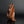 Load image into Gallery viewer, A sculptural monkey-shaped incense burner by Tsuda Eiju, distinguished by its upright seated pose and smoothly modelled brown surface. The animal raises its face, creating a lively expression while retaining the compact, self-contained outline of a small metal sculpture.

The rounded body rests on its haunches, with long forelimbs descending towards the base. A broad oval area defines the flank, introducing a shallow change in contour against the curved torso. The head is carefully simplified, with projecti
