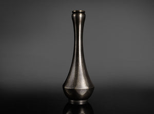 Bronze vase on a dark gray background