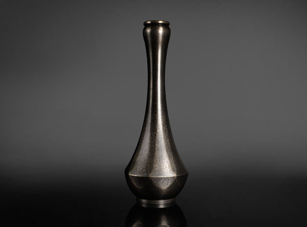Bronze vase on a dark gray background
