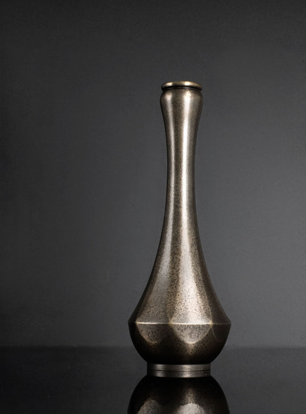 Bronze vase on a dark gray background