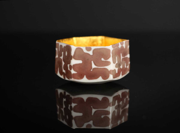 A Gilt Decorated Guinomi with a geometric pattern on a black background