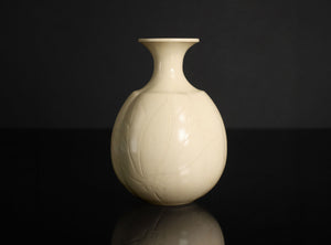 White ceramic sake bottle on a black background