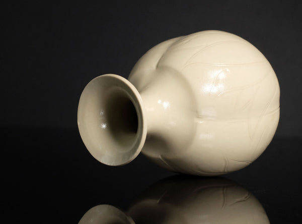 White textured sake bottle on a black background