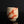 Load image into Gallery viewer, A handmade ceramic tea cup with a textured beige clay body and diagonal reddish-brown glaze stripes, set against a dark gray background with a reflective black surface below.
