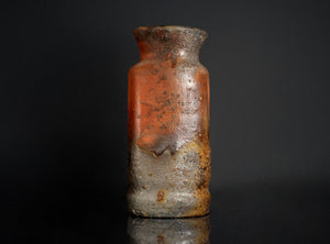 Rust-colored vase on a black background