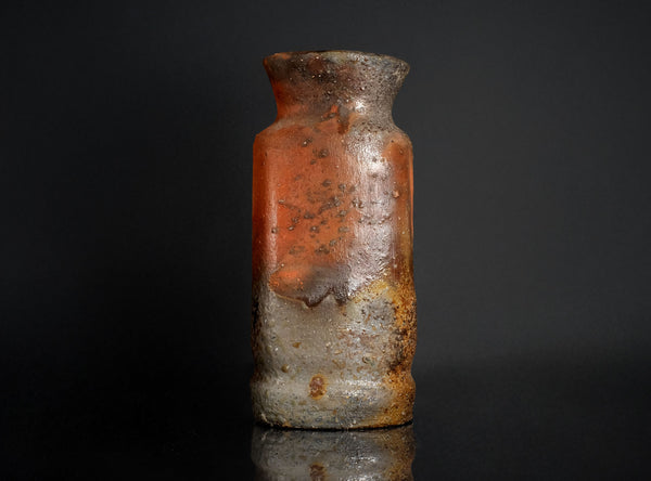 Rust-colored vase on a black background
