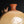 Load image into Gallery viewer, Close-up of a ceramic jug with a rounded body, narrow neck, and three small bird-like handles on the shoulder, shown against a dark background.
