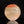 將圖片載入到圖庫檢視器中， A polished natural stone sculpture with a hagi ensai flattened vase, disc-like shape, featuring a color gradient from warm orange-red at the top to light beige and cream at the bottom, displayed on a reflective black surface against a solid black background.
