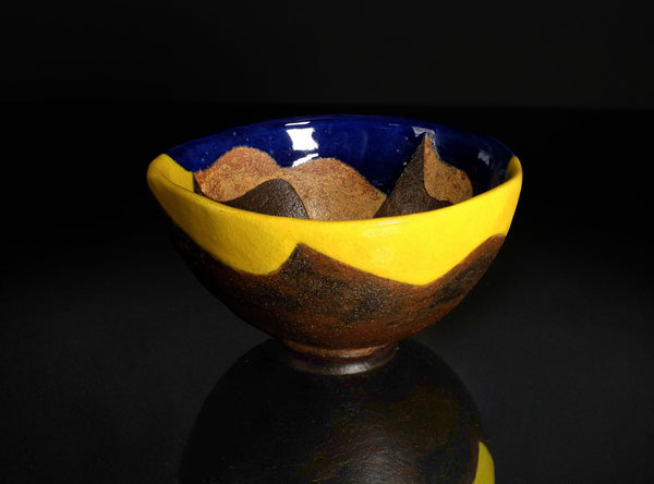 Ceramic bowl with multicolored design on a black background