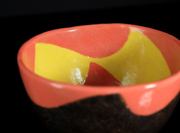 Close-up of a red and yellow object with a black background