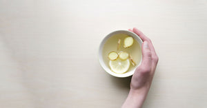 A cup of white tea with lemon and ginger